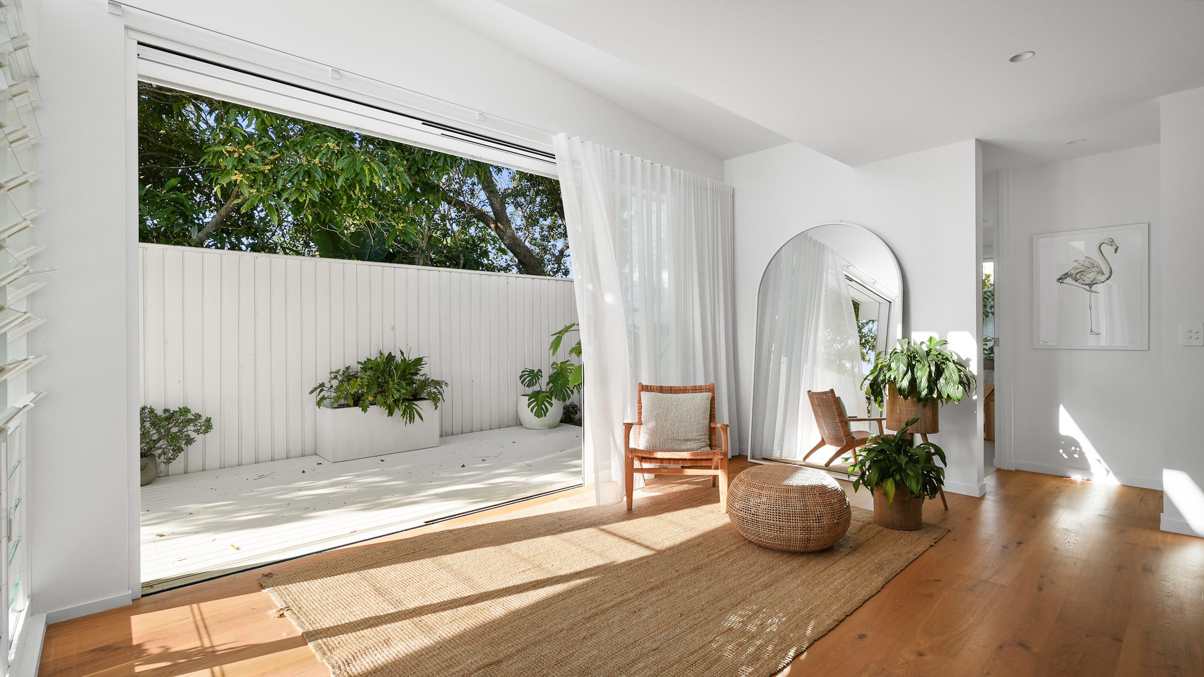 Sunroom with sheers and rattan chair